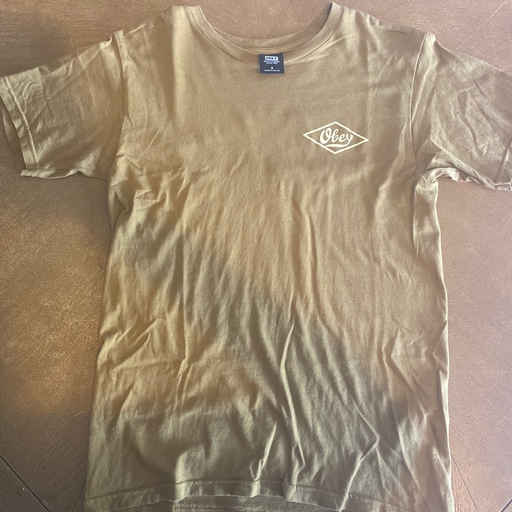 Tan colored obey shirt